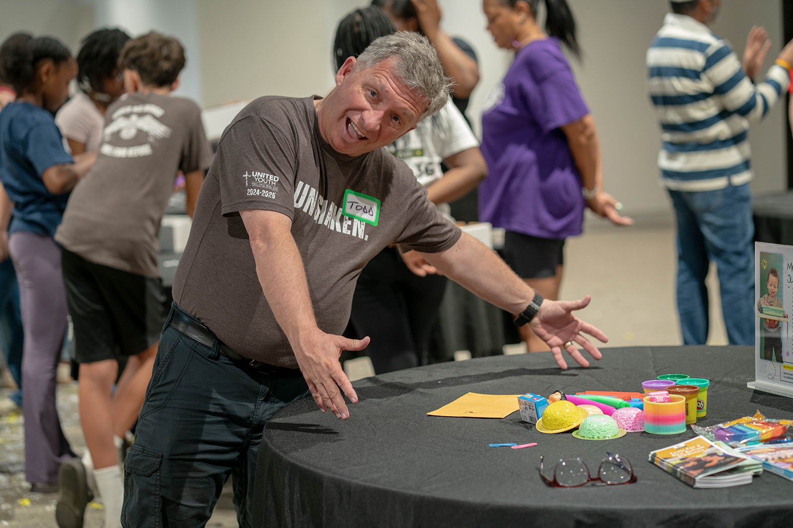 An ECHO volunteer leading an activity at a table of colorful supplies